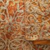 A luxury, heavily beaded orange George fabric. consisting of 2 wrappers and a blouse. 6 and 1/2 to 7 yards in all.